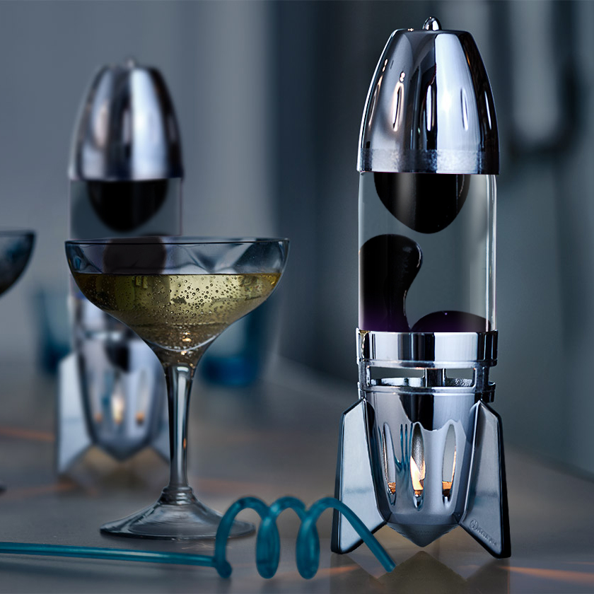 Lampe à lave à bougie Mathmos Fireflow avec corps argenté, liquide transparent et lave noire, accent d'intérieur moderne sur une table